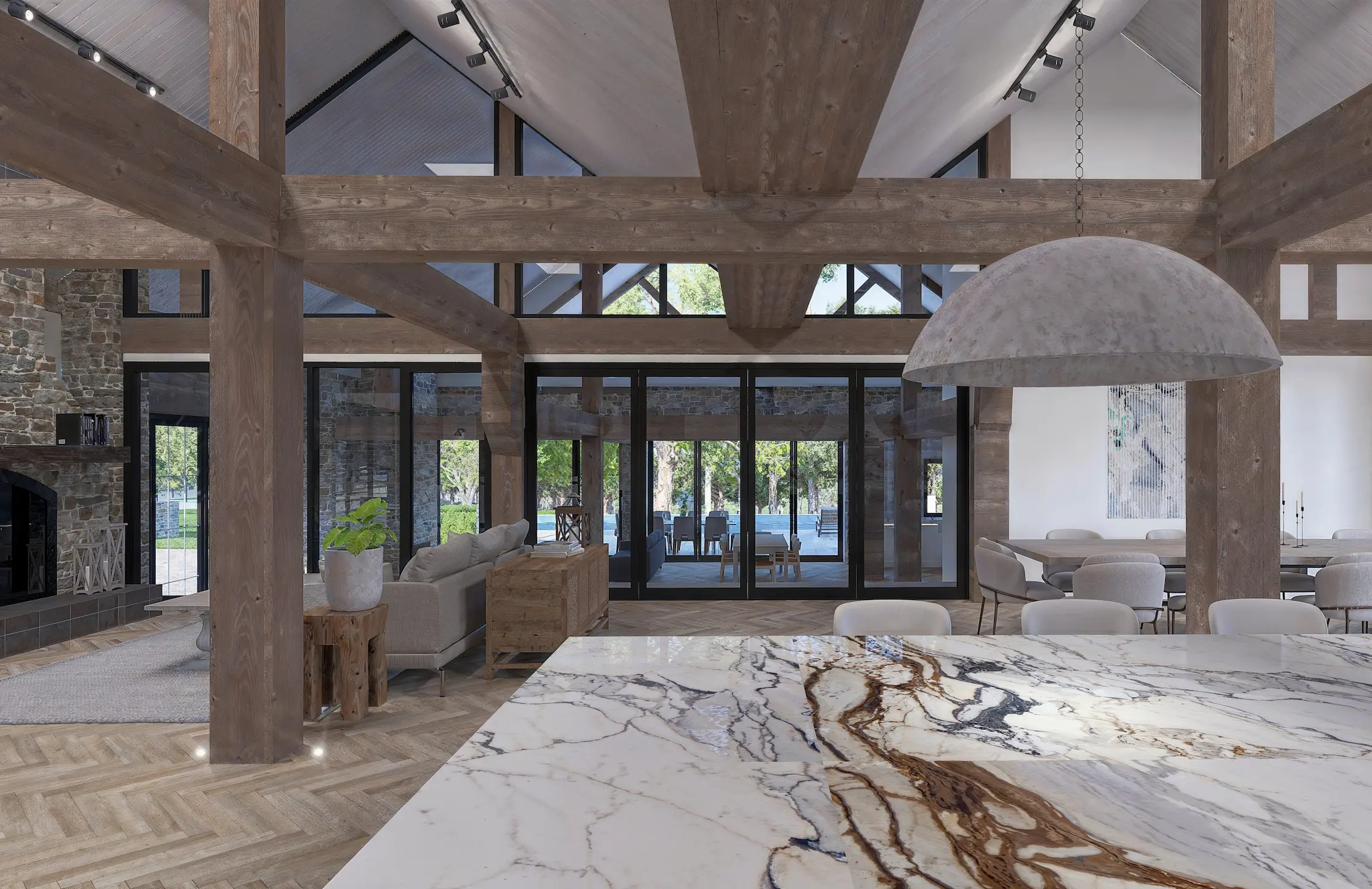Open-plan interior with exposed timber beams, marble island and stone fireplace
