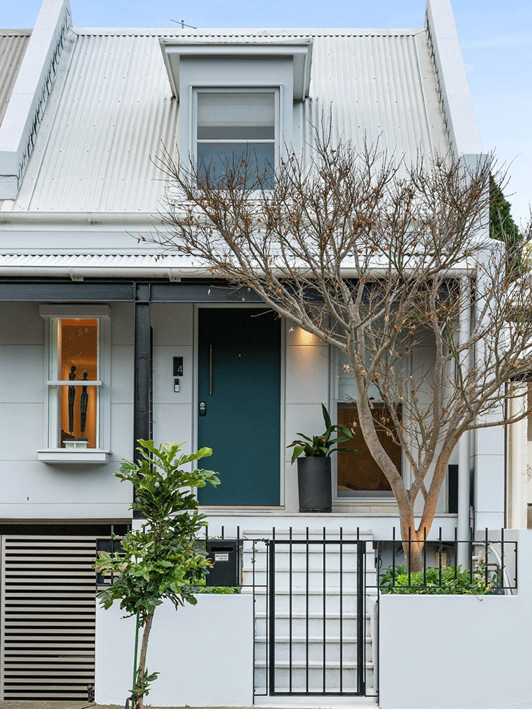 Modern terrace facade with light cladding, metal roof and dark front door